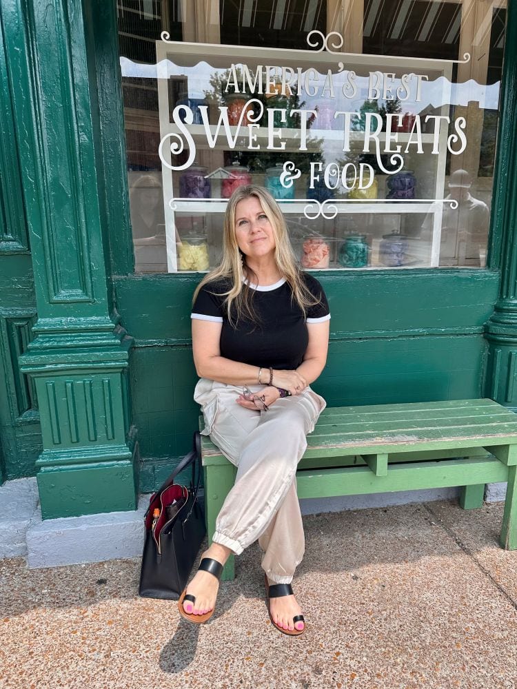 Bev sitting on a bench in front of Crown Candy waiting for a table, a St. Louis ice cream shop.