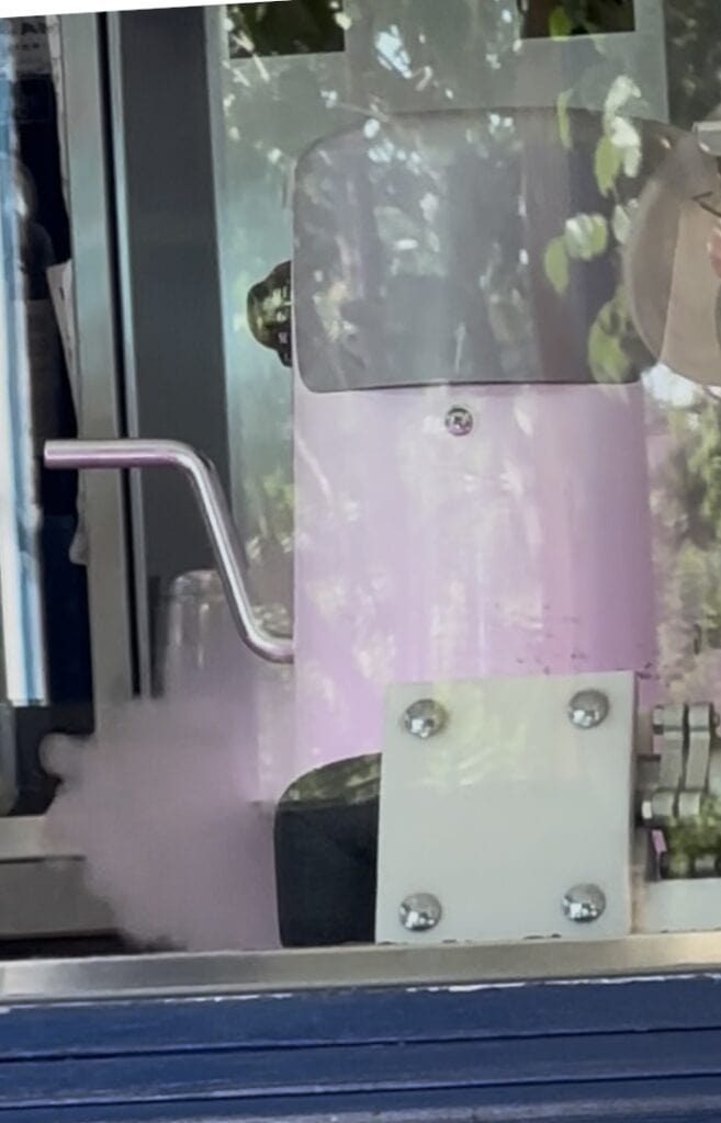 The flash steam from the flash-churned process of making ice cream using nitro, the pink color from the pink lights behind the mixer, at Ices Plain & Fancy, where flash-churned ice cream is made.