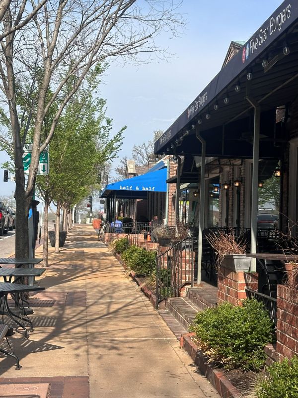 Exterior of Half & Half with bright blue awnings. A best breakfast in St Louis.