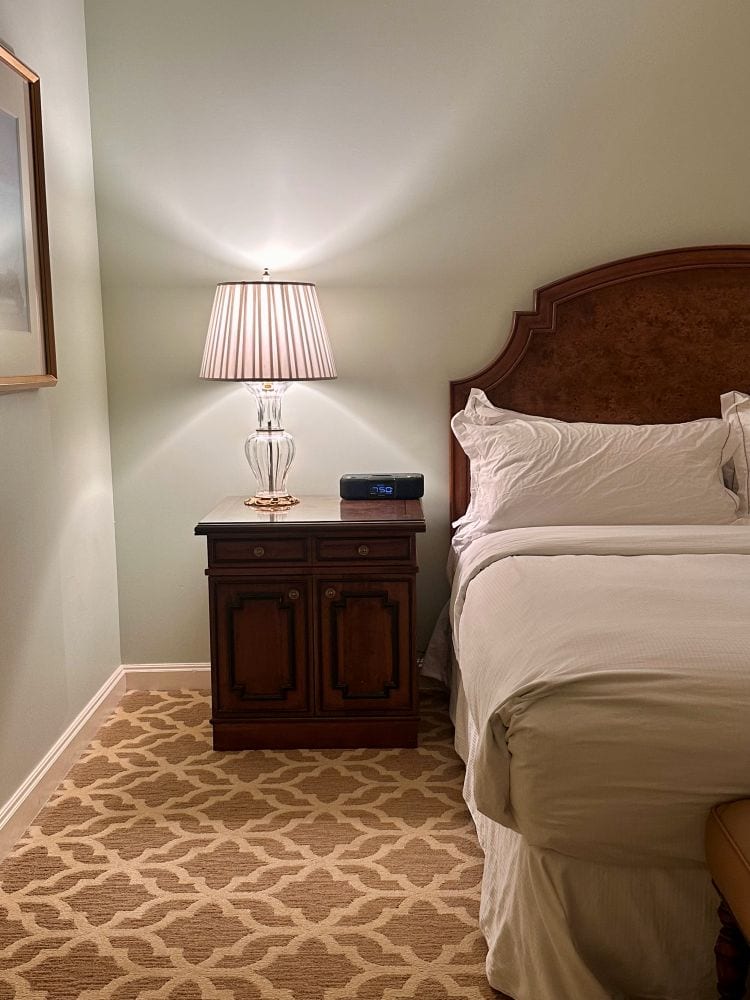 The bed, side table and lamp on a guest room at Hilton Lake Las Vegas, one of the best hotels in Las Vegas off the Strip.