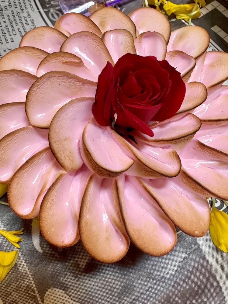 A pastry at Creme de la Creme Albuqurque, pink icing that looks like petals, a small rose in the center.