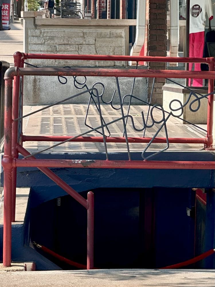 The entrance to Hugo's, down the steps into the basement of a building in downtown Fayetteville, Arkansas.