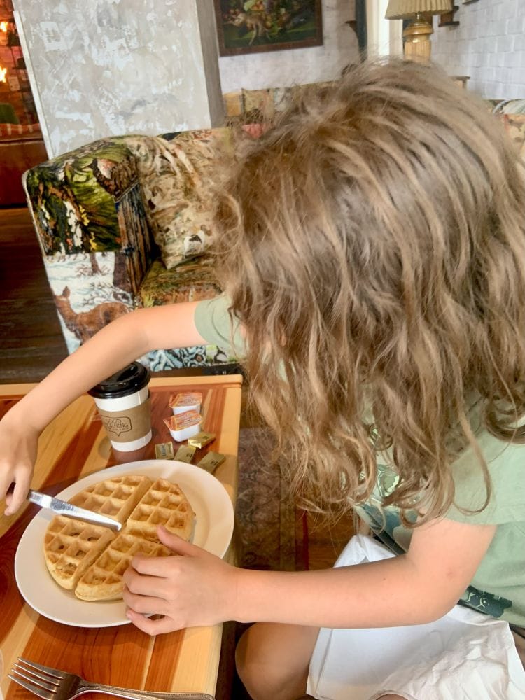 My grandson enjoying his waffle in the lobby of The Graduate Hotel in downtown Fayetteville, Arkansas.