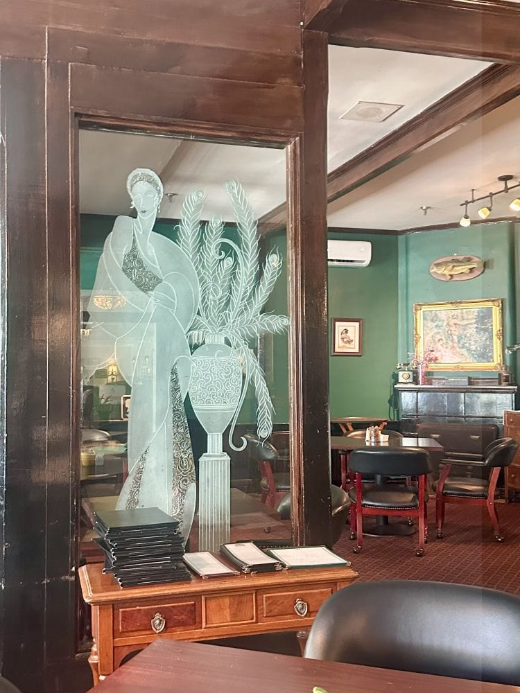 An etched image of a woman on a glass window in Tremain's Tavern in historic Mount Dora.