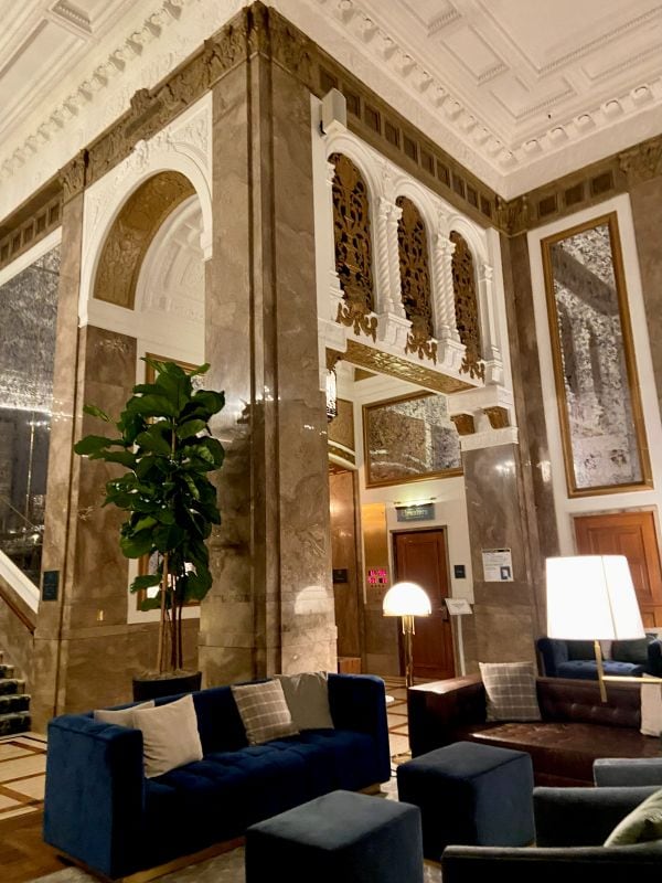 The beautiful lobby of The Beacon Grand with white ceilings, lots of molding detail in the walls, a cozy city holiday stay in San Francisco.