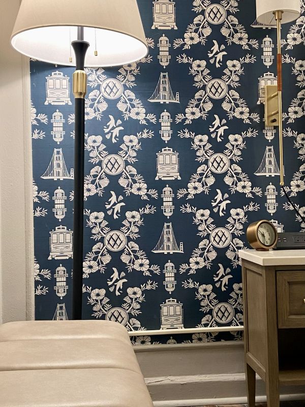 The custom blue and white wallpaper with San Francisco icons on it, in a guest room at The Beacan Grand, a cozy holiday stay in San Francisco.