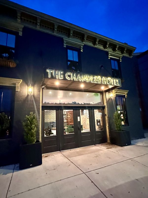 The black and gold exterior of The Chandler Hotel in Madison, Indiana, a cozy holiday stay.