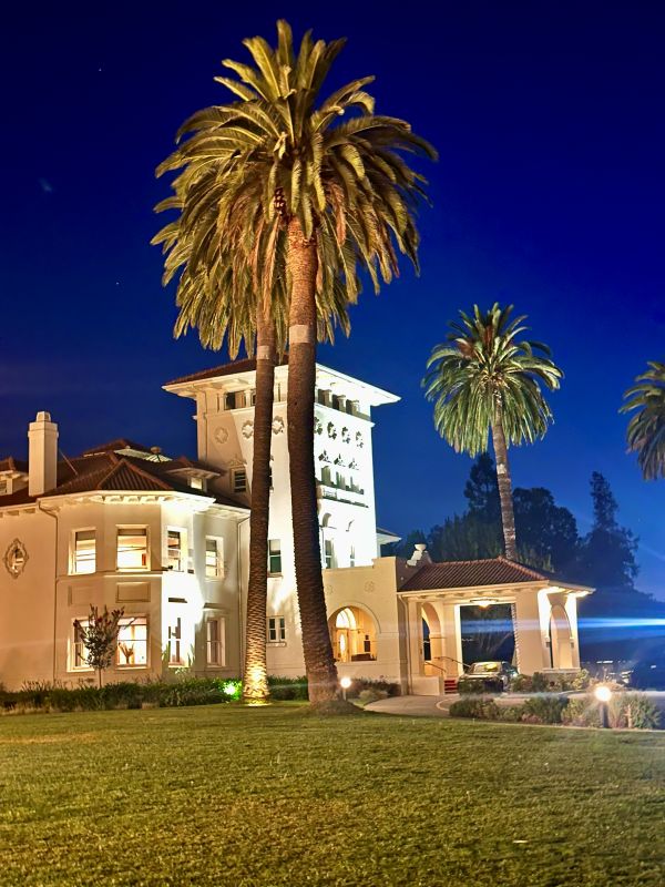 A view from the outside at night of the Hayes Mansion in San Jose.