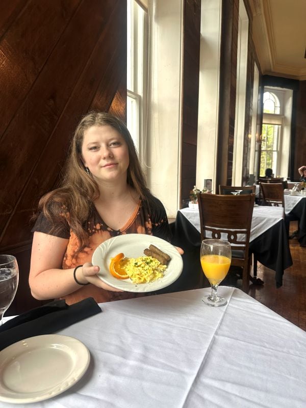 My granddaughter showing her plate of food for breakfast during our weekend at the 1886 Crescent Hotel Eureka Springs.