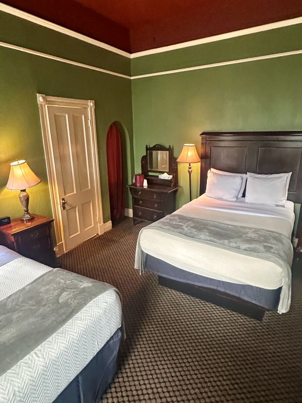A guest bedroom in period colors of green and red, at the Crescent Hotel during our weekend in Eureka Springs. At the 1886 Crescent Hotel Eureka Springs