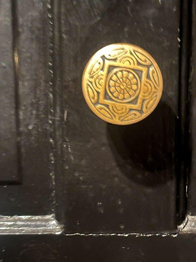 An intricate gold doorknob on a guest room door at the 1886 Crescent Hotel Eureka Sprins.