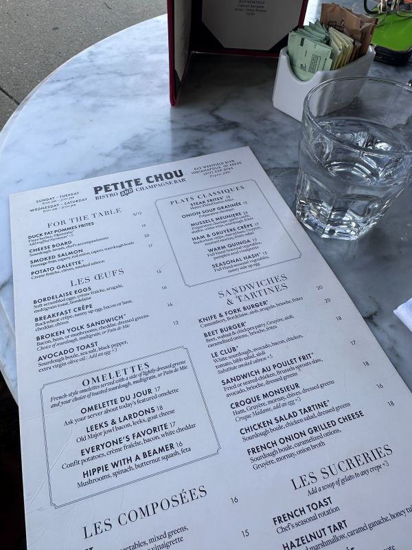 The menu sitting on a bistro table at Petite Chou Bistro and Champagne Bar a local restaurant for breakfast in Indianapolis