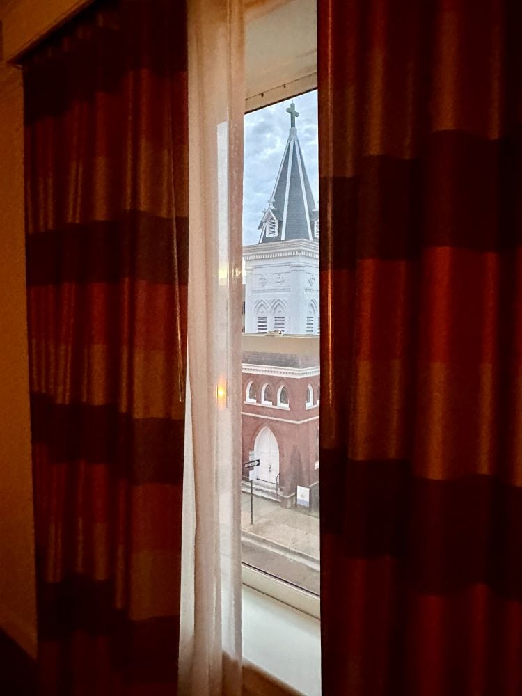 A view out the window through the red curtains of the guest room window at the Alluvian Hotel, on my MIssissippi road trip.