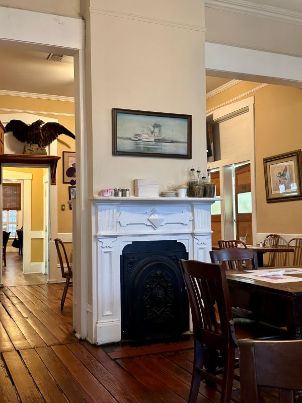 Inside the Walnut Hills restaurant, tables, and an old fireplace in Vicksburg, on my Mississippi road trip.