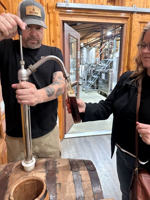 Bev is filling her bottle with Kentucky Single Barrel Straight Bourbon Whiskey, 117 proof (and a little help, of course) at Neeley Bourbon.