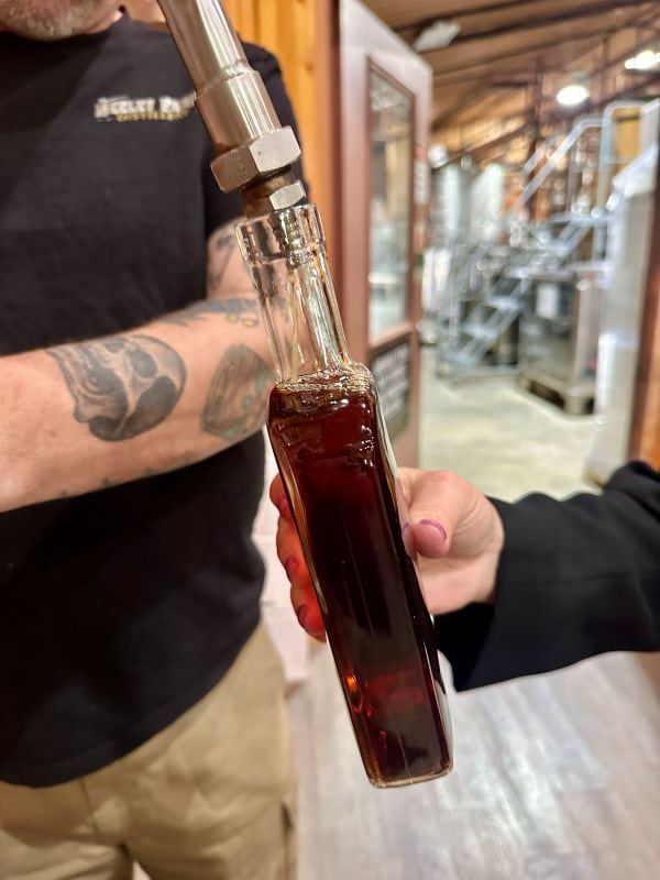 A close up of the bourbon filling up the bottle at Neeley Bourbon.
