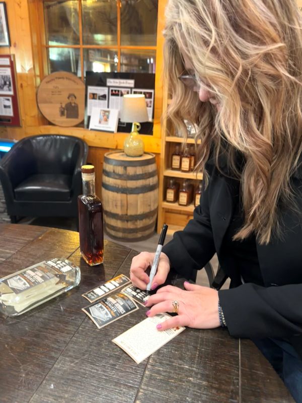 Bev filling in her labels with the bourbon information at Neeley Bourbon.