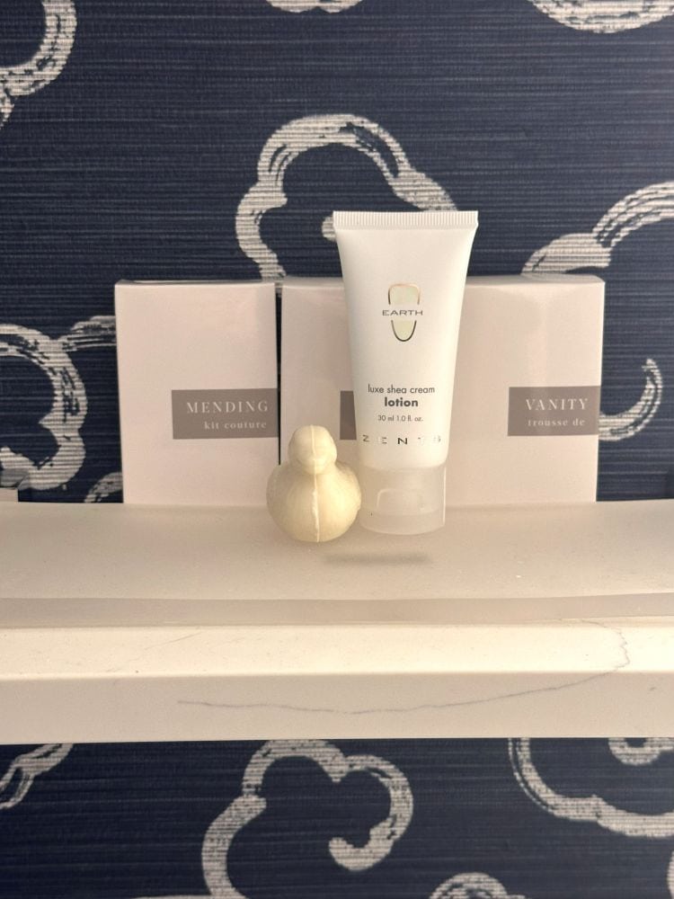 A duck soap, soap in the shape of a small duck on the shelf with other presonal toiletries in the bathroom of a guest room at The Peabody Hotel in Memphis TN.