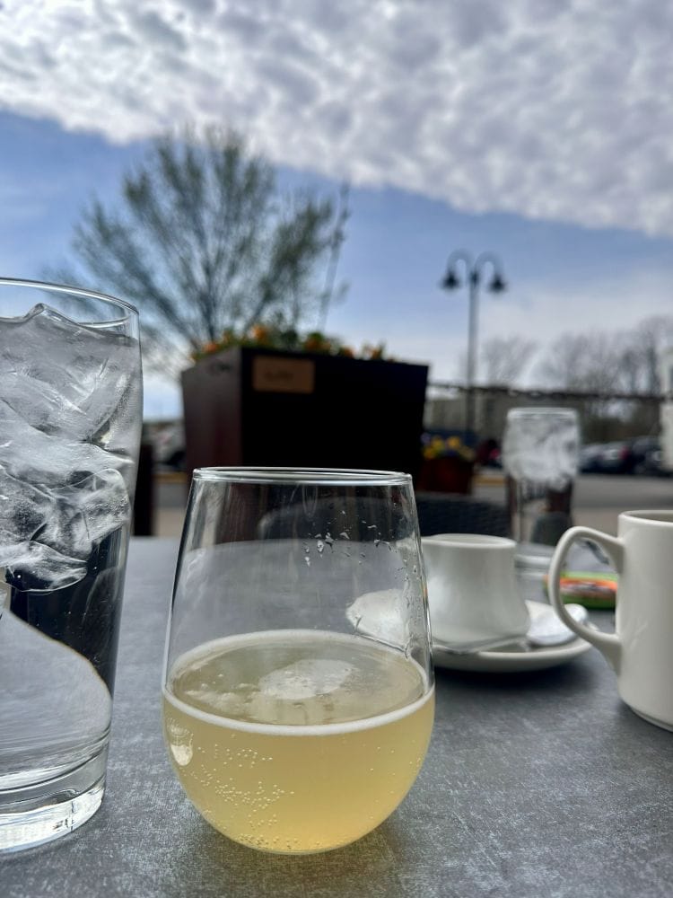 A mimosa on the table of the ground floor breakfast, brunch and lunch restaurant Rize at the Ironworks Hotel, an industrial style hotel in Indianapolis.