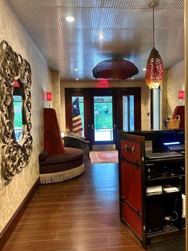 The lobby with the desk to the right, looking past it to the front entry doors at the Chestnut Hill Hotel Philadelphia.
