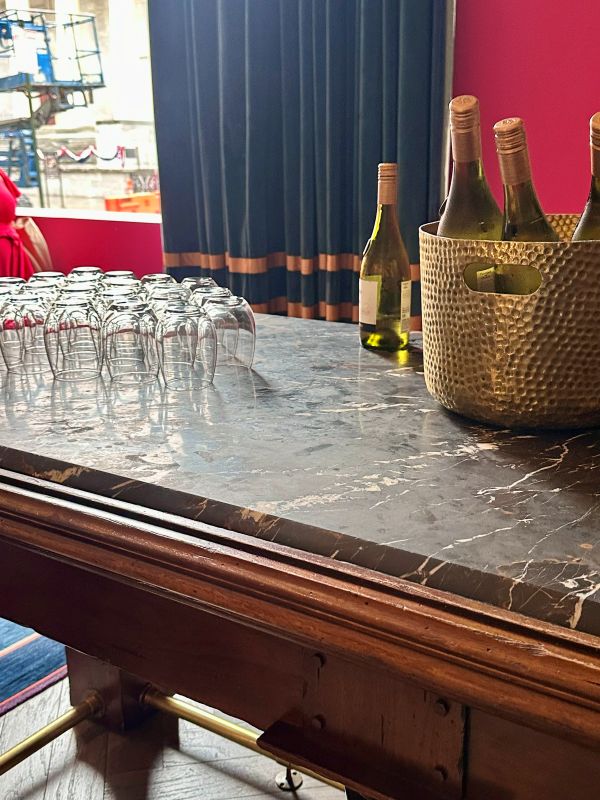 Wine glasses and wine on a table in the lobby for the wine happy hour at the Kimpton Monaco, a hotel near Independence Hall.