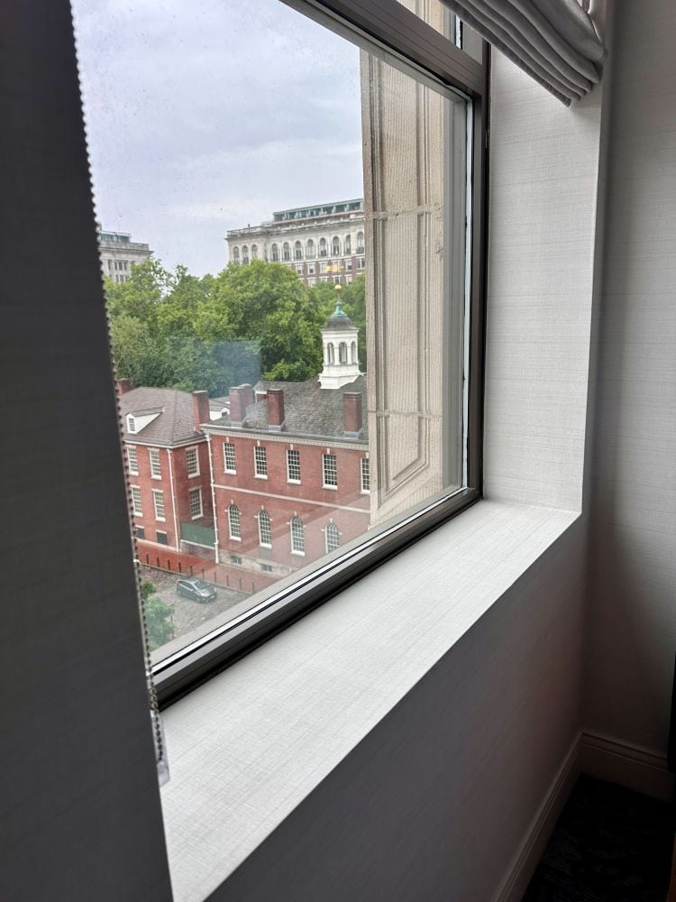 The view of Independence Hall from a guest room at Kimpton Hotel Monaco, a hotel near Independence Hall.