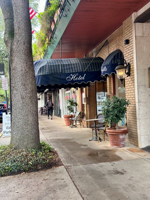 The exterior entrance of the Park Plaza Hotel with the dark blue awning in Winter Park Florida.