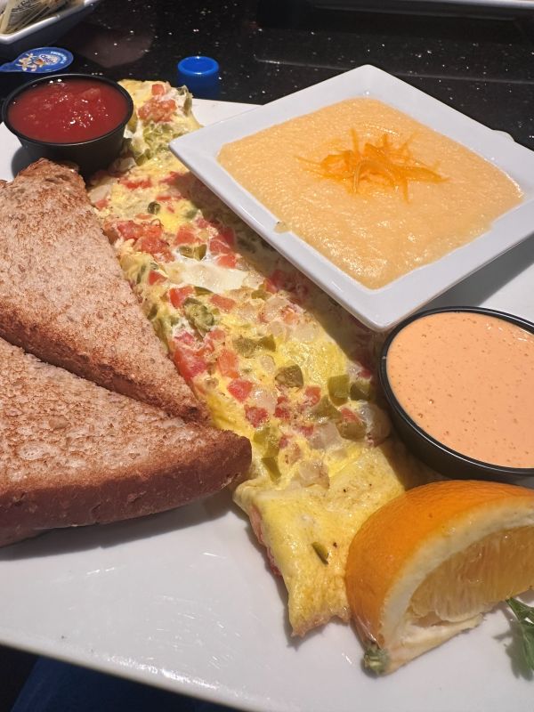 An omelete with grits and petal sauce at Keke's in Winter Park Florida.