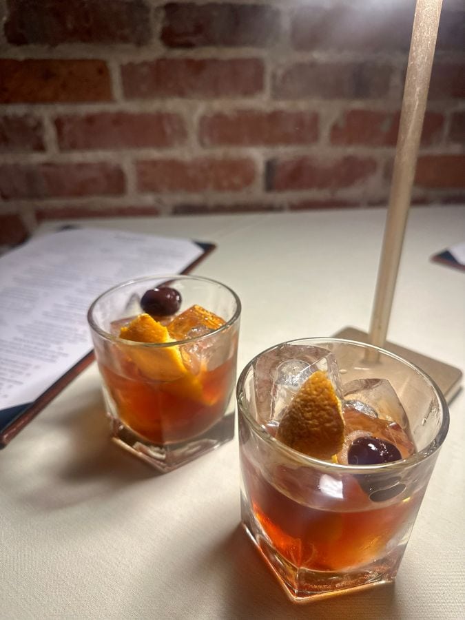 Two Old Fashioneds on a dinner table at BoVine in Winter Park Florida.