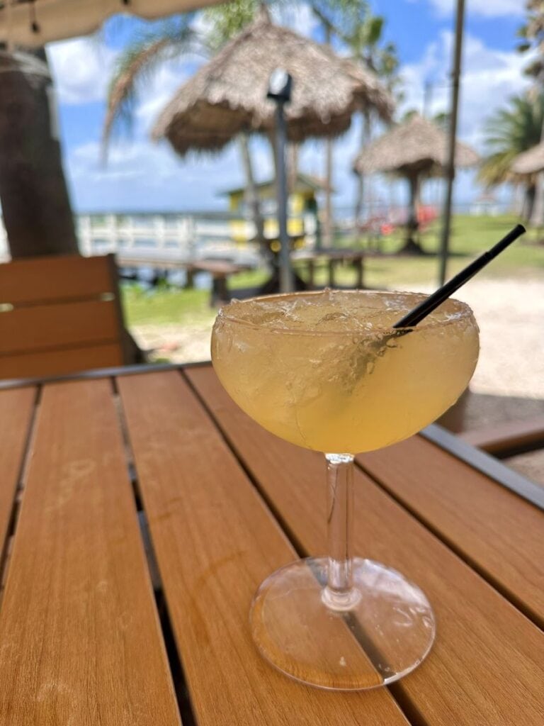 A margarita with the lake in the background at Lazy Gator Bar.