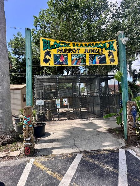 The banner sign to the live exhibit of birds and alligators at the Lazy Gator Bar.