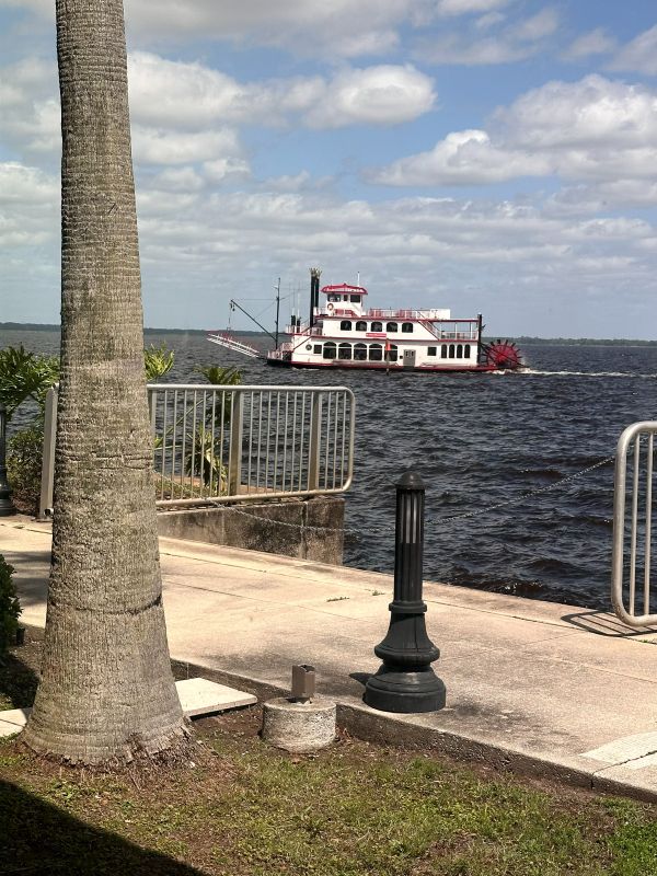 A paddleboat on the water in front of St. Johns River Steak and Seafood in Sanford Florida.