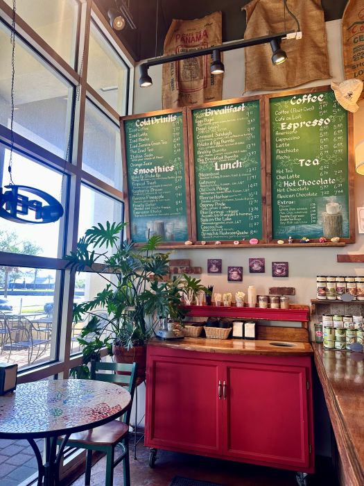 The green chalkboard menu board and red cabinet with coffee stand at Caffe Di Riverwalk in Sanford Florida.