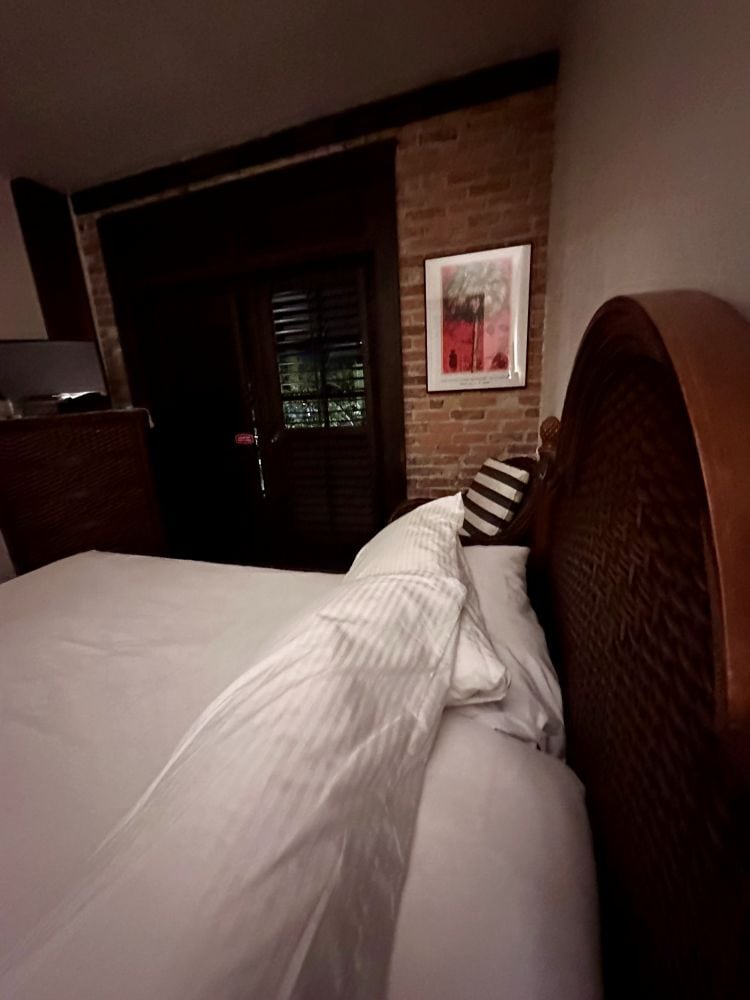 A side view of a bed and pillows in a guest room at the Park Plaza Hotel, a Winter Park Florida hotel.
