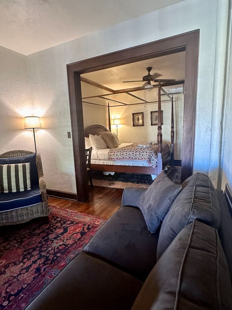 A view from the sitting room into the bedroom of a Front Balcony Room at the Park Plaza Hotel, a Winter Park Florida Hotel.
