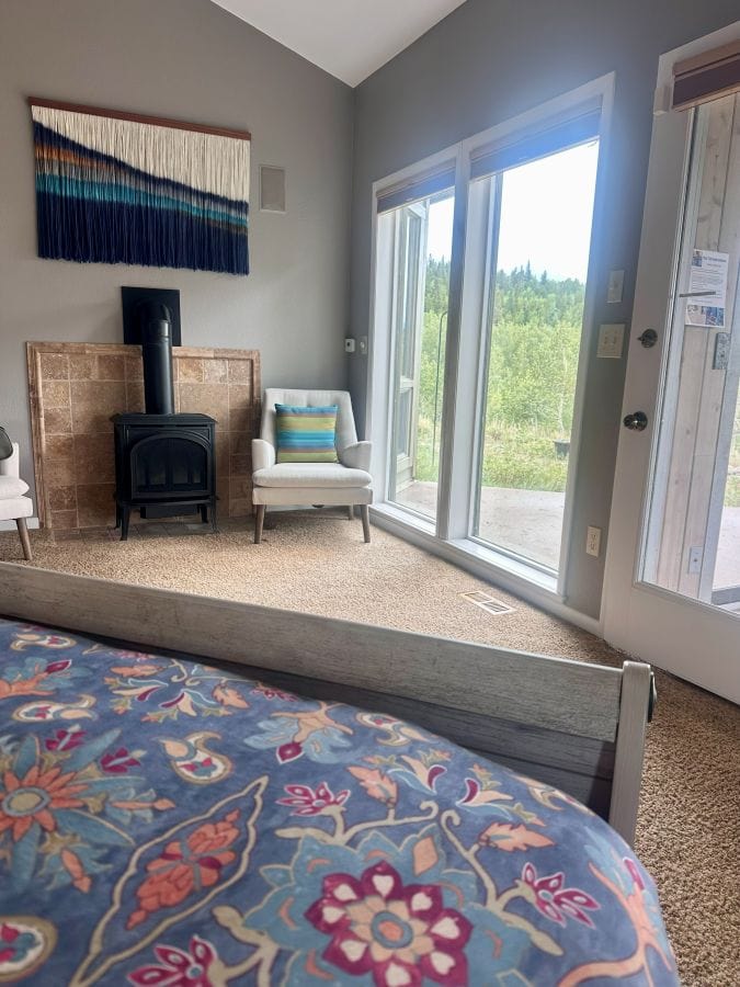 A view out the glass doors from the bed in the master bedroom at Alpina Haus on our Colorado mountain retreat.
