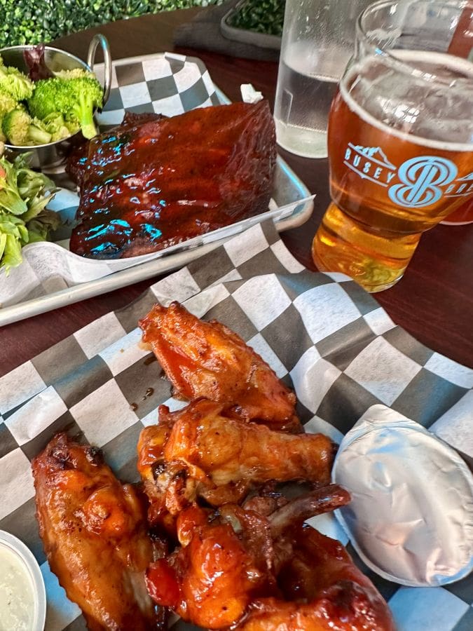 Smoked wings, BBQ Ribs and a beer on the table at Busey Brews on our Colorado mountain retreat.