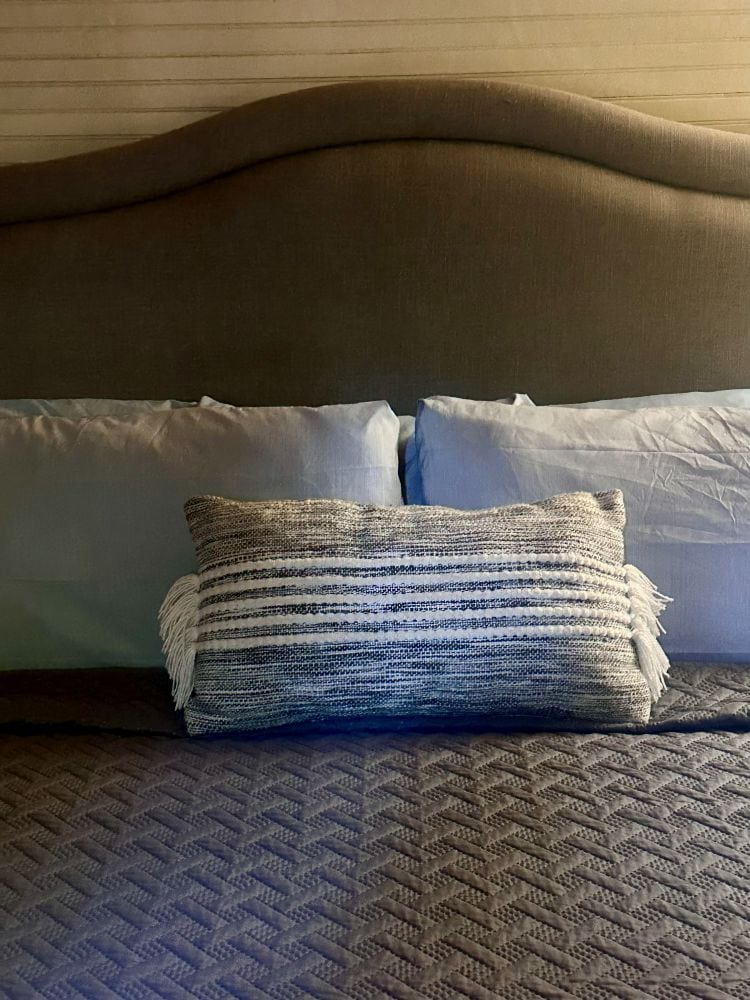 The pillows, bed and headboard in a bedroom at Brown Mountain Beach Resort.