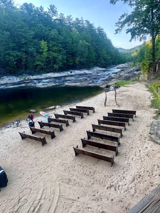 The beach at Brown Mountain Beach Resort set up with pews for a wedding.