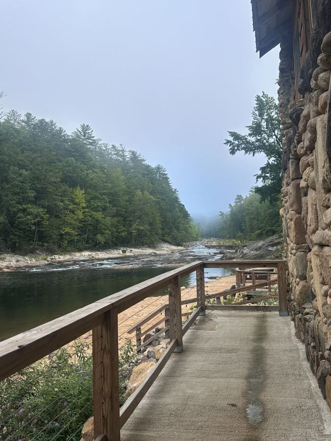 A view from the deck of the creek and forest at Brown Mountain Beach Resort.