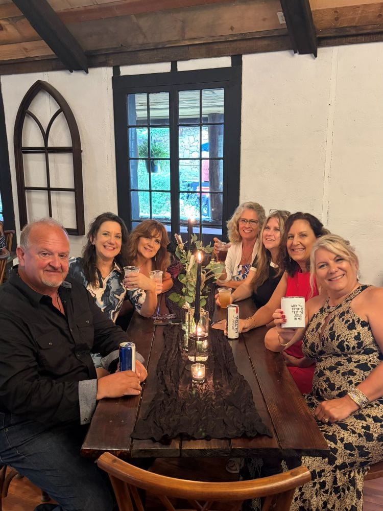 Vicki, her husband, the sisters and me and Maria at a table for dinner after the wedding at Brown Mountain Beach Resort.