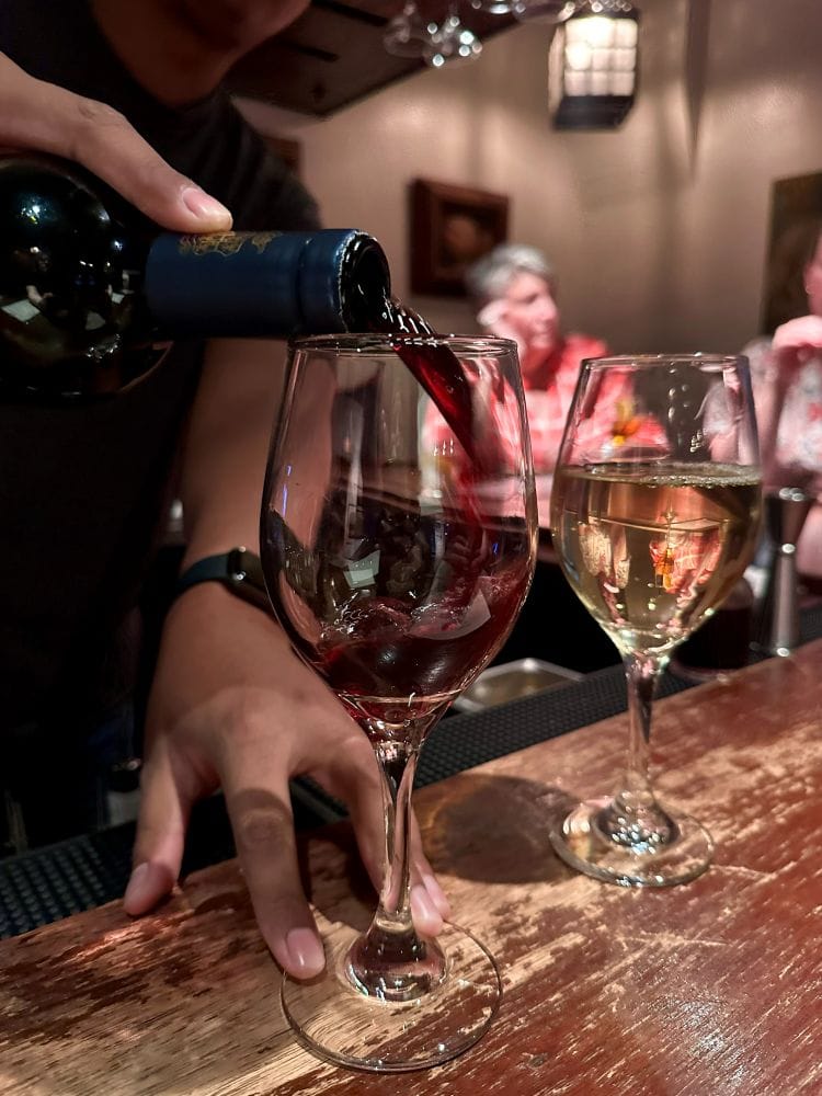 Pouring red wine into a glass at Bar Bianco in Phoenix, Arizona.