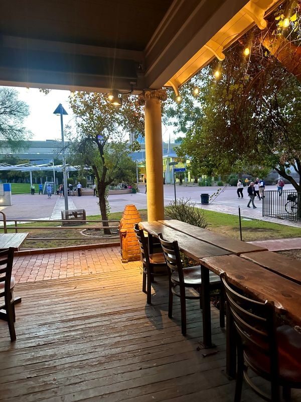 Outdoor porch seating with trees and city view at Bar Bianco in Phoenix, Arizona.