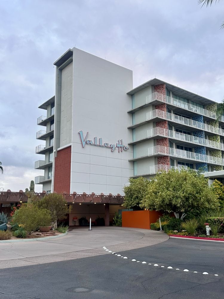 Modern hotel building with balconies and greenery at Hotel Valley Ho in Scottsdale, Arizona.