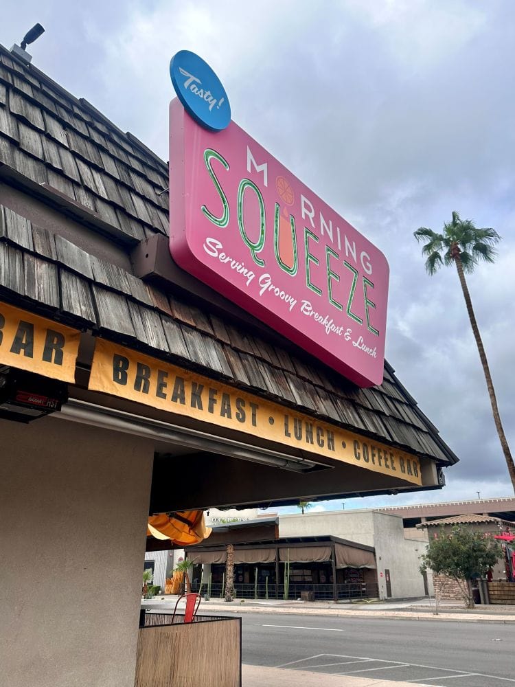 Colorful Morning Squeeze sign with palm trees in Scottsdale, Arizona.