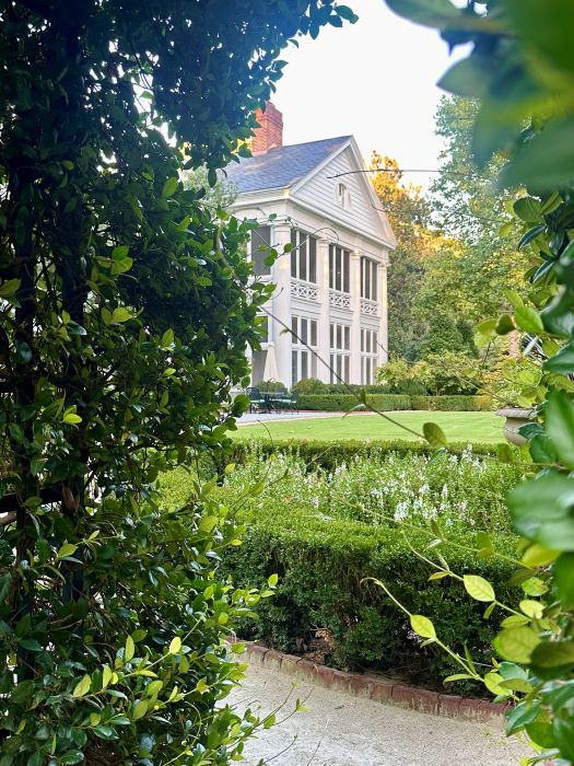 A view of the Duke Mansion through the garden.