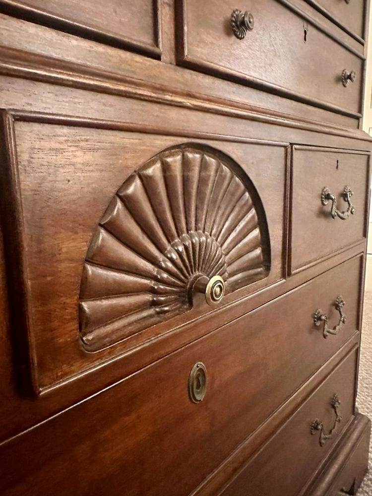 Fan detail on a wood dresser in a guest room at the Duke Mansion.