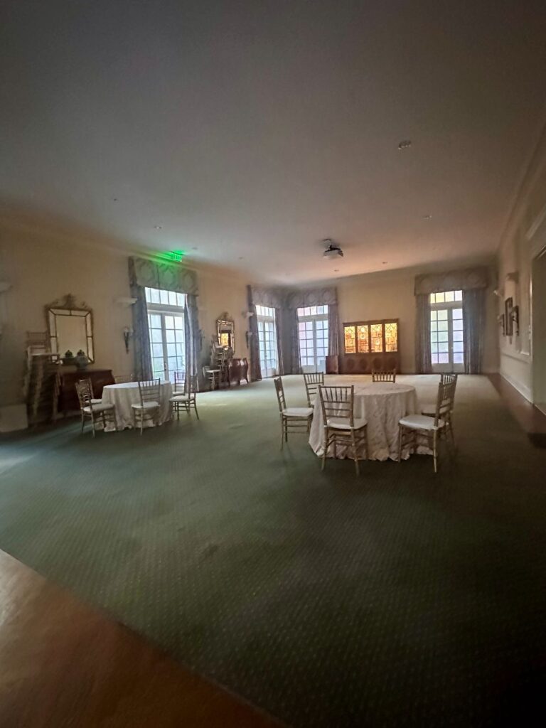 The original living room, empty with a few tables, at the Duke Mansion.