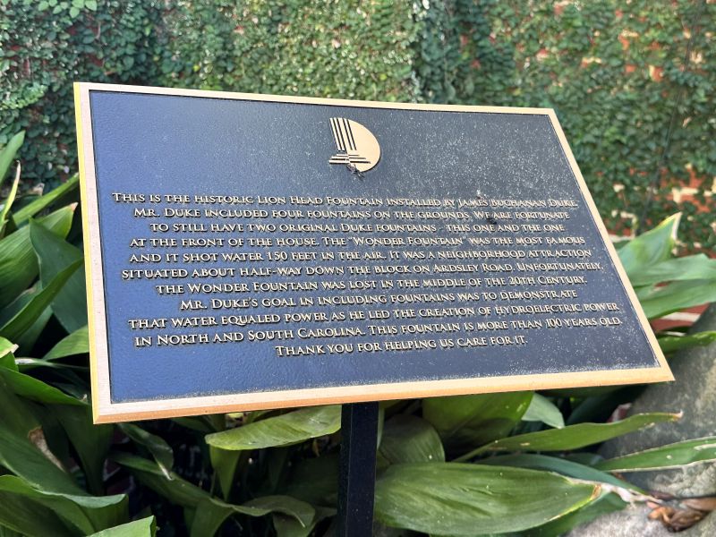 The bronze plaque next to the Lion Fountain explining the historicl significance of the fountain at the Duke Mansion.