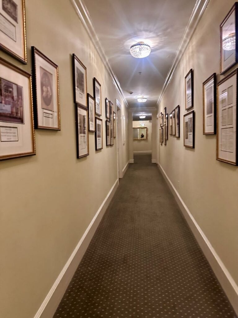 The third floor hall with framed images of the history of this house, the Duke Mansion, one of the historic hotels in Charlotte.